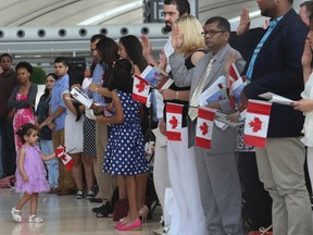 New Canadians were sworn in Monday at a citizenship ceremony held at Pearson International Airport. (JACK BOLAND, Toronto Sun)