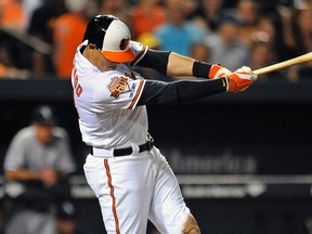 Baltimore Orioles third baseman Manny Machado (13) singles in the seventh inning against the Chicago White Sox at Oriole Park at Camden Yards. Mandatory Credit: Joy R. Absalon-USA TODAY Sports
