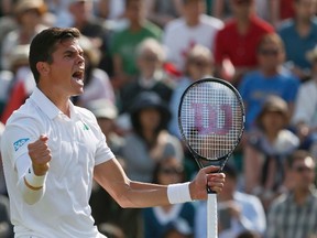 Milos Raonic  reacts after defeating Kei Nishikori of Japan in their men's singles tennis match at the Wimbledon Tennis Championships, in London July 1, 2014.        REUTERS/Stefan Wermuth