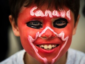 A boy with his face painted in Canadian national colours poses for a picture during Canada Day, on the East York Canada Day Parade route in Toronto July 1, 2014.    REUTERS/Mark Blinch