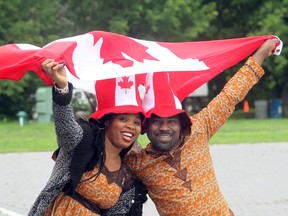 Kemi (l) and Samson Oyeyiola celebrate Canada Day during festivities at Assiniboine Park in Winnipeg, Man. Tuesday July 01, 2014.
Brian Donogh/Winnipeg Sun/QMI Agency