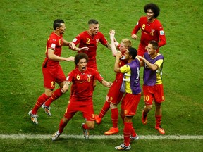 Belgium's Kevin De Bruyne (third right) forms a heart shape with his hands as his teammates gather around him to celebrate his goal against the U.S. during extra time in their World Cup game at the Fonte Nova arena in Salvador, Brazil on Tuesday, July 1, 2014. (Ruben Sprich/Reuters)
