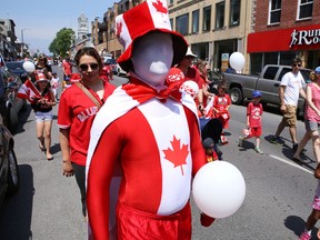 No face, but lots of national pride, mark one participant in the Canada Day Red and White Parade along Princess Street on Tuesday. ELLIOT FERGUSON/THE WHIG-STANDARD