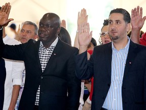 (left) Innocent Ndira, originally from Burundi, is sworn-in during a citizenship ceremony at Fort Edmonton Park, in Edmonton Alta., on Tuesday July 1, 2014. Seventy-three new Canadians from 29 countries were sworn-in during the ceremony. David Bloom/Edmonton Sun/QMI Agency