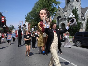 Members of the Shadowland Theatre walk along Princess Street during Tuesday's Canada Day Red and White Parade in Kingston. ELLIOT FERGUSON/THE WHIG-STANDARD
