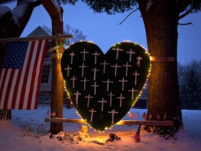 A heart that bears 26 crosses for each victim is surrounded by lights the Sandy Hook portion of Newtown, Connecticut in a December 14, 2013 file photo. (REUTERS/Carlo Allegri/files)