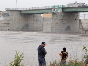 People fish near the Red River Floodway gates in Winnipeg, Man. Tuesday July 01, 2014. (Brian Donogh/QMI Agency)