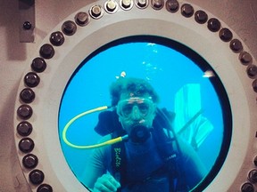Fabien Cousteau, grandson of underwater pioneer Jacques-Yves Cousteau, looks through the window of the Aquarius habitat near the deep coral reef in the Florida Keys National Marine Sanctuary, Florida, in this undated handout picture provided by Mission 31. (REUTERS/Mission 31/Handout via Reuters)
