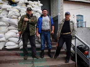 Members of a group of separatists pose for a picture outside an office in the town of Druzhkovka, Donetsk region, June 2, 2014.   REUTERS/Gleb Garanich
