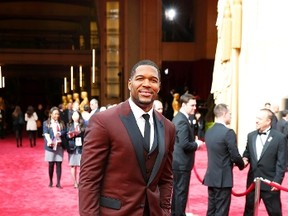Former NFL football player and TV personality Michael Strahan arrives on the red carpet the 86th Academy Awards in Hollywood, California March 2, 2014.  REUTERS/Mike Blake