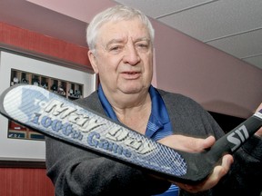 Rick Jeanneret, at home in Niagara Falls, Ont., on November 24, 2011, with May Day stick that former NHLer Brad May gave him. (MIKE DIBATTISTA /NIAGARA FALLS REVIEW/QM AGENCY)