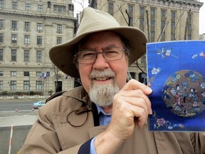 During a tour of Shanghai, writer Ian Robertson holds a photo of an 1890s embroidered cape a great-great uncle brought back from the Chinese city when they had business interests there.  (PHOTO BY STEPHEN SMITH/MYCOMPASSTV.CA)