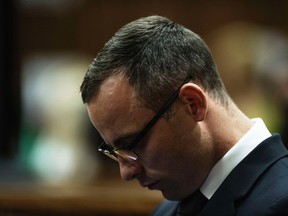 South African Olympic and Paralympic track star Oscar Pistorius sits in the dock, during the trial for the murder of his girlfriend Reeva Steenkamp, in the North Gauteng High Court in Pretoria, May 14, 2014.  (REUTERS/Gianluigi Guercia/Pool)