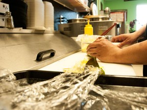 A temporary foreign worker in a restaurant in Whitecourt, Alberta. Bryan Passifiume photo | QMI Agency