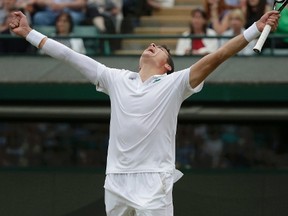 Milos Raonic of Canada reacts after defeating Nick Kyrgios of Australia in their men's singles quarter-final tennis match against at Wimbledon. (REUTERS)