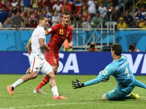 Belgium's goalkeeper Thibaut Courtois (right) saves a shot by US forward and captain Clint Dempsey during a Round of 16 football match between Belgium and USA at Fonte Nova Arena in Salvador during the 2014 FIFA World Cup on July 1, 2014. (AFP PHOTO/ FRANCISCO LEONG)