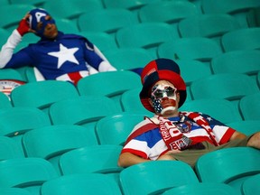 U.S. fans show dejection at the end of the extra time of the 2014 World Cup round of 16 game between U.S. and Belgium at the Fonte Nova arena in Salvador July 1, 2014. (REUTERS/Sergio Moraes)