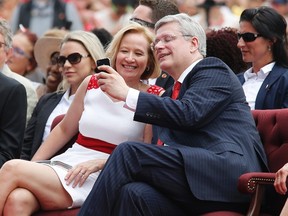 Canada's Prime Minister Stephen Harper takes a 'selfie' with his wife Laureen during Canada Day celebrations on Parliament Hill in Ottawa July 1, 2014. Canadians are celebrating their country's 147th birthday. (REUTERS/Chris Wattie)