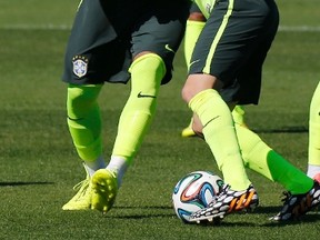 Brazil's Oscar and Maicon (in blue) fight for the ball during a training session in Teresopolis, near Rio de Janeiro, on Wednesday, July 2, 2014. (Marcelo Regua/Reuters)