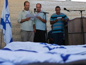 Avi Fraenkel, Ofir Shaer and Ori Yifrah (L-R), fathers of the three Israeli teens who were abducted and killed in the occupied West Bank, read their eulogies during their sons' joint funeral in the Israeli city of Modi'in July 1, 2014. Tens of thousands of mourners joined in an outpouring of national grief on Tuesday at the burial of the three Israeli teenagers, Gil-Ad Shaer, U.S.-Israeli national Naftali Fraenkel, both 16, and Eyal Yifrah, 19, whose kidnapping and killing Israel blamed on the Palestinian Islamist group Hamas. The Islamist group has neither confirmed nor denied involvement in the disappearance of the students as they hitchhiked near a Jewish settlement on June 12 nor in the cross-border rocket salvoes from Gaza. REUTERS/Baz Ratner