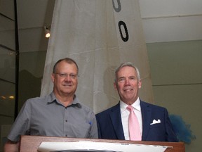 Kingston's Marine Museum of the Great Lakes board chair Chris West, left, and museum manager Doug Cowie with the first Laser built during the Evolution of Sail exhibit at the museum. (Ian MacAlpine/The Whig-Standard)