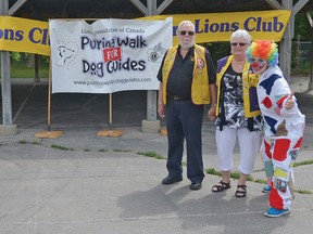 Suzanne Bowker and 6-month-old dog guide in training Mimi join Mayor (and Lion) Dave Beres and Lions Vern and Terry Fleming, and Stella the Clown (representing the kids activity area for the Walk) at Memorial Park to help promote the Purina Walk for Dog Guides in Tillsonburg on Saturday July 12. Two courses will be available in the Lake Lisgar area at 1 km and 3 km. CHRIS ABBOTT/TILLSONBURG NEWS