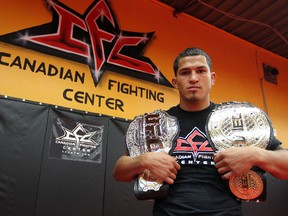 UFC lightweight champion Anthony Pettis holds his hardware at the Canadian Fighting Championship gym in Winnipeg last September. (Kevin King/QMI Agency)