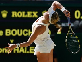 Eugenie Bouchard of Canada serves during her women's singles semi-final tennis match against Simona Halep of Romania at the Wimbledon Tennis Championships, in London July 3, 2014. (REUTERS/Stefan Wermuth)