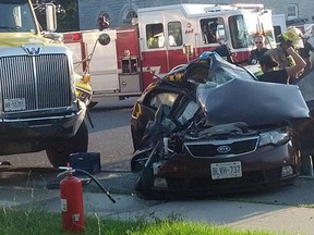 Rescue workers attend to a vehicle that collided with a truck Wednesday evening. The woman driving the car was sent to hospital with life-threatening injuries. Police said the truck was northbound on Montreal St and the four-door sedan was eastbound on Railway St approaching Rideau St. Photo submitted by Hendrick Kempenaar