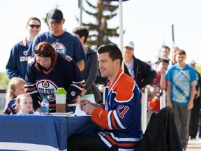 Edmonton Oilers' Andrew Ference signs autographs, outside of Rexall Place, on Saturday before the locker room sale began in Edmonton, Alberta on June 7th, 2014.  Chad Steeves/ Edmonton Sun