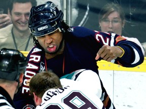 Edmonton Oilers Georges Laraque fights with Anaheim Mighty Ducks Todd Fedoruk during first period NHL action at Rexall Place in Edmonton, Alta., on Feb. 6, 2006. (Edmonton Sun/QMI Agency)