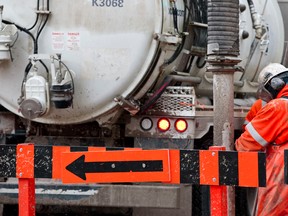 An EPCOR crew works on a water main break downtown earlier this year. (Ian Kucerak/Edmonton Sun file)