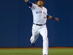 Colby Rasmus of the Toronto Blue Jays misses a one hop in the first inning during the season opener between the Toronto Blue Jays and the New York Yankees during MLB action at the Rogers Centre in Toronto, Ont. on Friday April 4, 2014. (DAVE ABEL/Toronto Sun files)