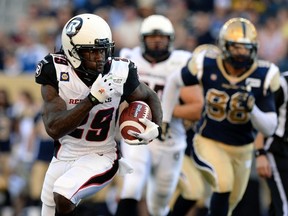 Ottawa Redblacks Chevon Walker (L) runs against the Winnipeg Blue Bombers. Walker had 656 yards rushing during 2012 in Hamilton and 336 yards in passing. He's looking to rebound after an off-season in 2013 -- when the Montego Bay, Jamaica native had just 193 yards on the ground and 90 in the air. REUTERS/Fred Greenslade