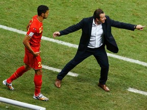 Belgium's coach Marc Wilmots gestures as Nacer Chadli (left) enters the field to substitute teammate Eden Hazard during extra time in their World Cup round of 16 game against the U.S. at the Fonte Nova arena in Salvador, Brazil on Tuesday, July 1, 2014. (Ruben Sprich/Reuters)