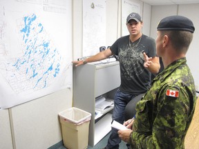 Aaron Hatton of South Frontenac Township talks with Sgt. Brangwyn Jones of the 41 Canadian Brigade Group as part of a military training course at CFB Kingston. ELLIOT FERGUSON/THE WHIG-STANDARD