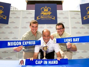 From left: Trainers Paul, Sid and Jamie Attard hold up the names of their respective horses at the draw for the Queen’s Plate at Woodbine Racetrack on Thursday. This will be Sid’s fifth entry at the Queen’s Plate, and the first time for his two sons. (Michael Burns photo)