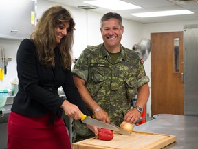 Catherine Reynolds and Master Warrant Officer Terry O’Hara in the Warrants and Sergeants Mess kitchen. (Chloe Sobel/For The Whig-Standard)
