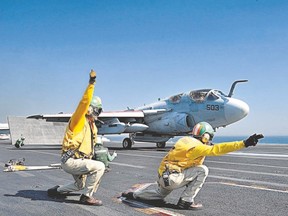Lt. Robert Arndt, left, and Lt. Christopher Cannon give the signal to launch an EA-6B Prowler off the flight deck of the aircraft carrier USS George H.W. Bush in June. The U.S. Navy is fighting suggestions to retire one of its 11 aircraft carriers, the USS George Washington, early. Maintenance on another carrier was delayed last year. This could make it harder to meet the apparently growing need for such ships, some officials say. (U.S Navy handout/AFP photo )
