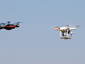 Drones hover during the 4th Intergalactic Meeting of Phantom's Pilots (MIPP) in an open secure area in the Bois de Boulogne, western Paris, March 16, 2014. (REUTERS/Charles Platiau)