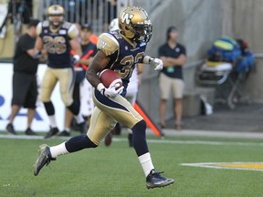 Winnipeg Blue Bombers RB Nic Grigsby trots into the Ottawa RedBlacks endzone for second-quarter touchdown during CFL action at Investors Group Field in Winnipeg, Man., on Thu., July 3, 2014. Kevin King/Winnipeg Sun/QMI Agency