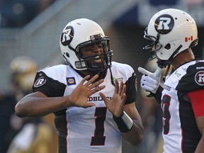 RedBlacks quarterback Henry Burris speaks with Marcus Henry following a touchdown during CFL action against the Blue Bombers in Winnipeg on Thursday, July 3, 2014. (Kevin King/QMI Agency)
