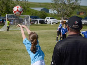 A Medicine Hat player takes a throw-in during the championship U-10 mini soccer match in Pincher Creek. Medicine Hat went on to win the game 1 - 0. John Stoesser photos/QMI Agency