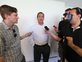 Kent Austin talks to reporters at Commonwealth Stadium on Thursday. (Perry Mah, Edmonton Sun)