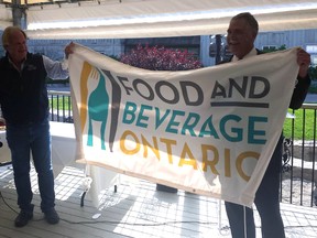 Steve Peters, right, executive director and Norm Beal, president of the Alliance of Ontario Food Processors, unveil the association's new name and logo: Food and Beverage Ontario.