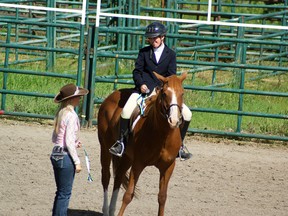 Megan McGlynn from the MD of Pincher Creek receives her silver medal in English Equitation from rodeo queen Chelsea Stokke on Day 3 of The Games. Greg Cowan photos/QMI Agency.