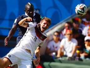 France's Mamadou Sakho and Germany's Thomas Mueller fight for the ball during their World Cup quarterfinal match at Maracana Stadium in Rio de Janeiro, July 4, 2014. (KAI PFAFFENBACH/Reuters)
