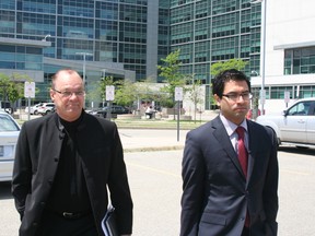 Peter McCallion, left, leaves Brampton court Friday with his lawyer, Amol Chiplunkar. (TERRY DAVIDSON/Toronto Sun)