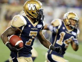 Winnipeg Blue Bombers defensive back Demond Washington runs a punt return down for a touchdown against the Ottawa RedBlacks during CFL football in Winnipeg, Man. Monday July 03, 2014.
Brian Donogh/Winnipeg Sun/QMI Agency