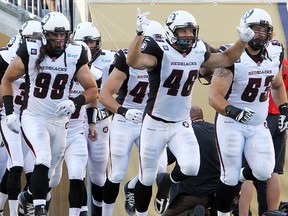 RedBlacks Marlon Smith (98), Jason Pottinger (46) and Matthew Albright (53) get set to hit the field Thursday in Winnipeg. (Brian Donogh//QMI Agency)